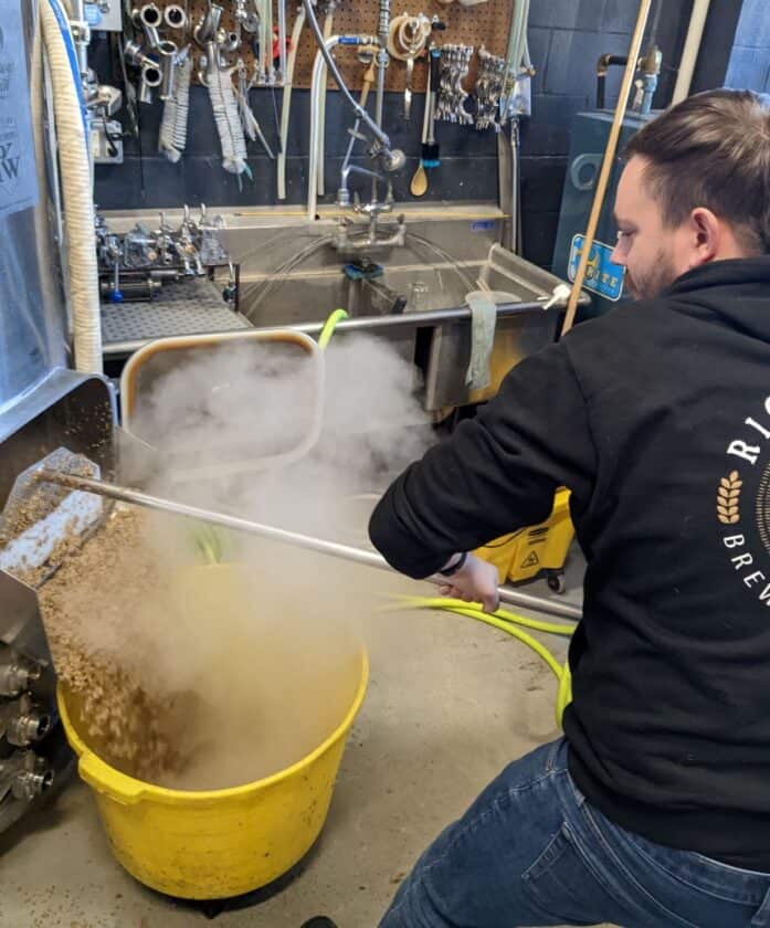 Brewing student Ryan Frost helps with the  brewing process