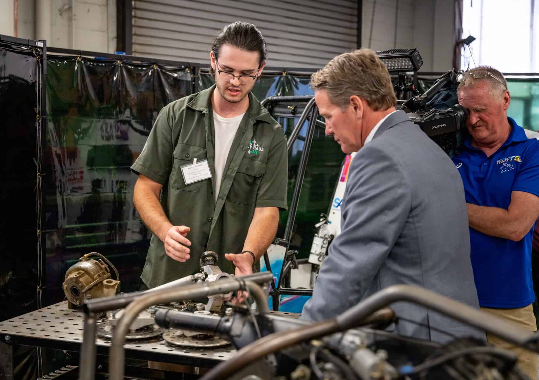 Mechanical Engineering Technology student Denver Nieman explained how parts were manufactured with a 5-axis Milling Machine