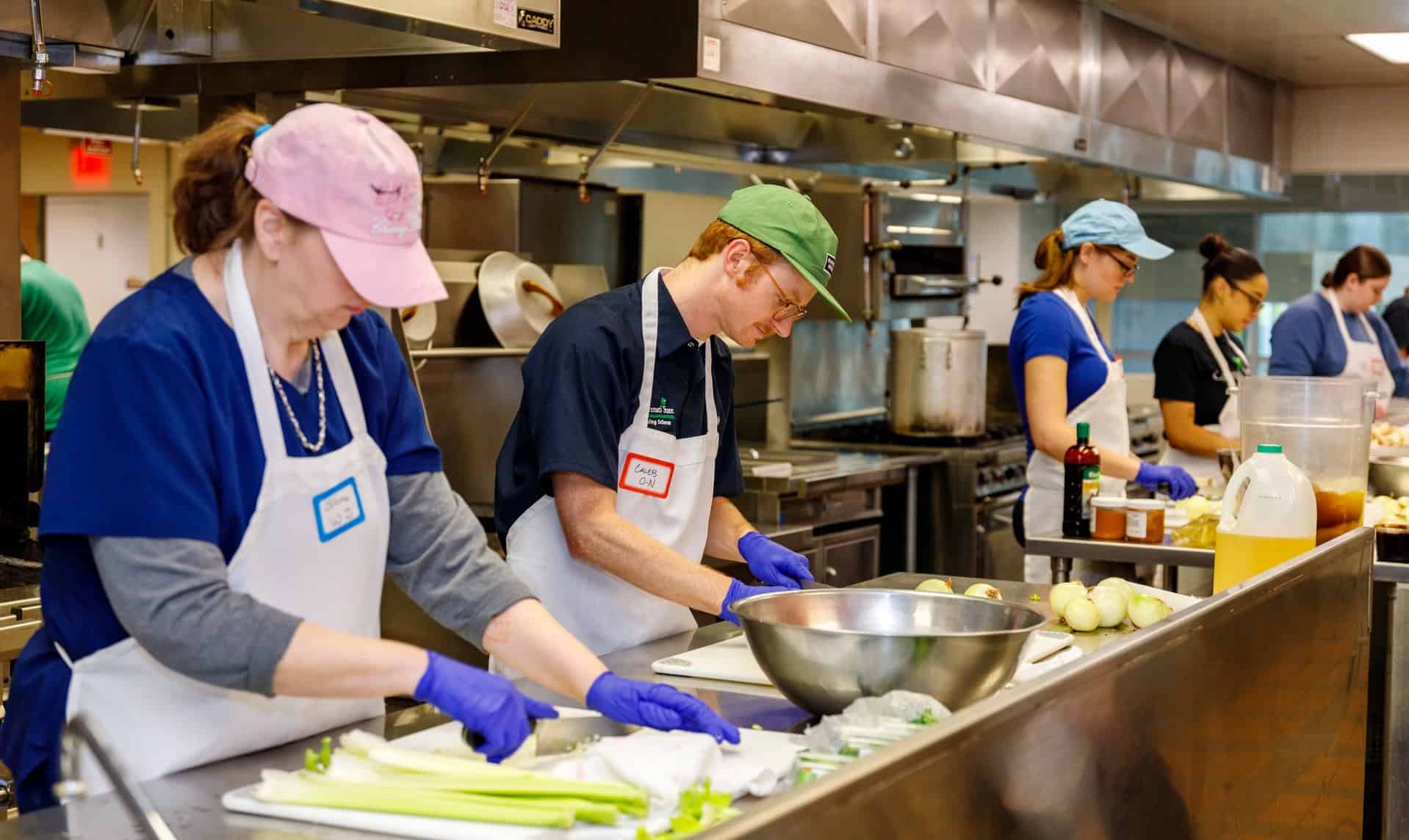 Faculty members JoAnne Worthington and Caleb Ochs-Naderer working in the kitchen