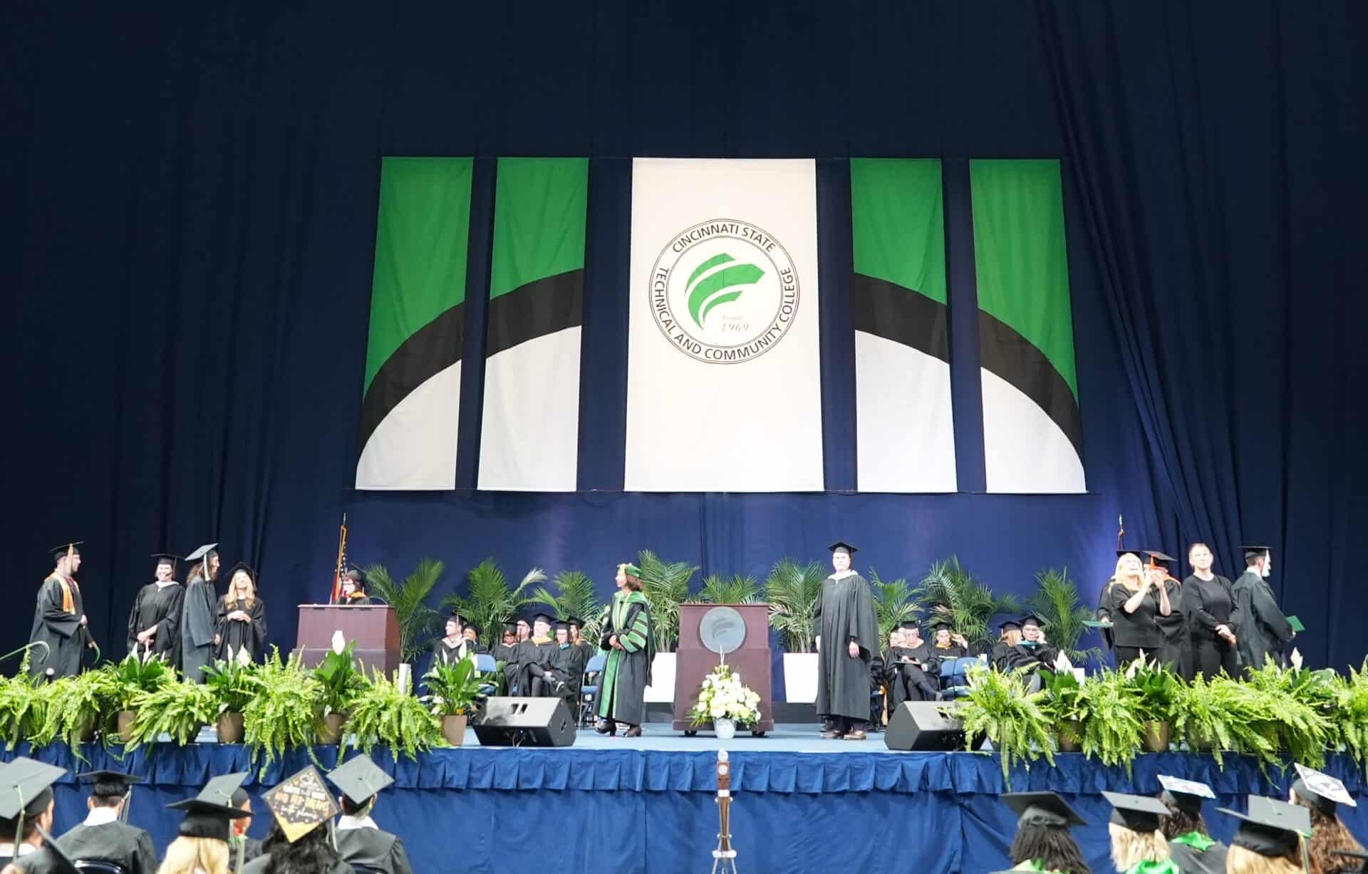 Graduates walking across the stage at Commencement