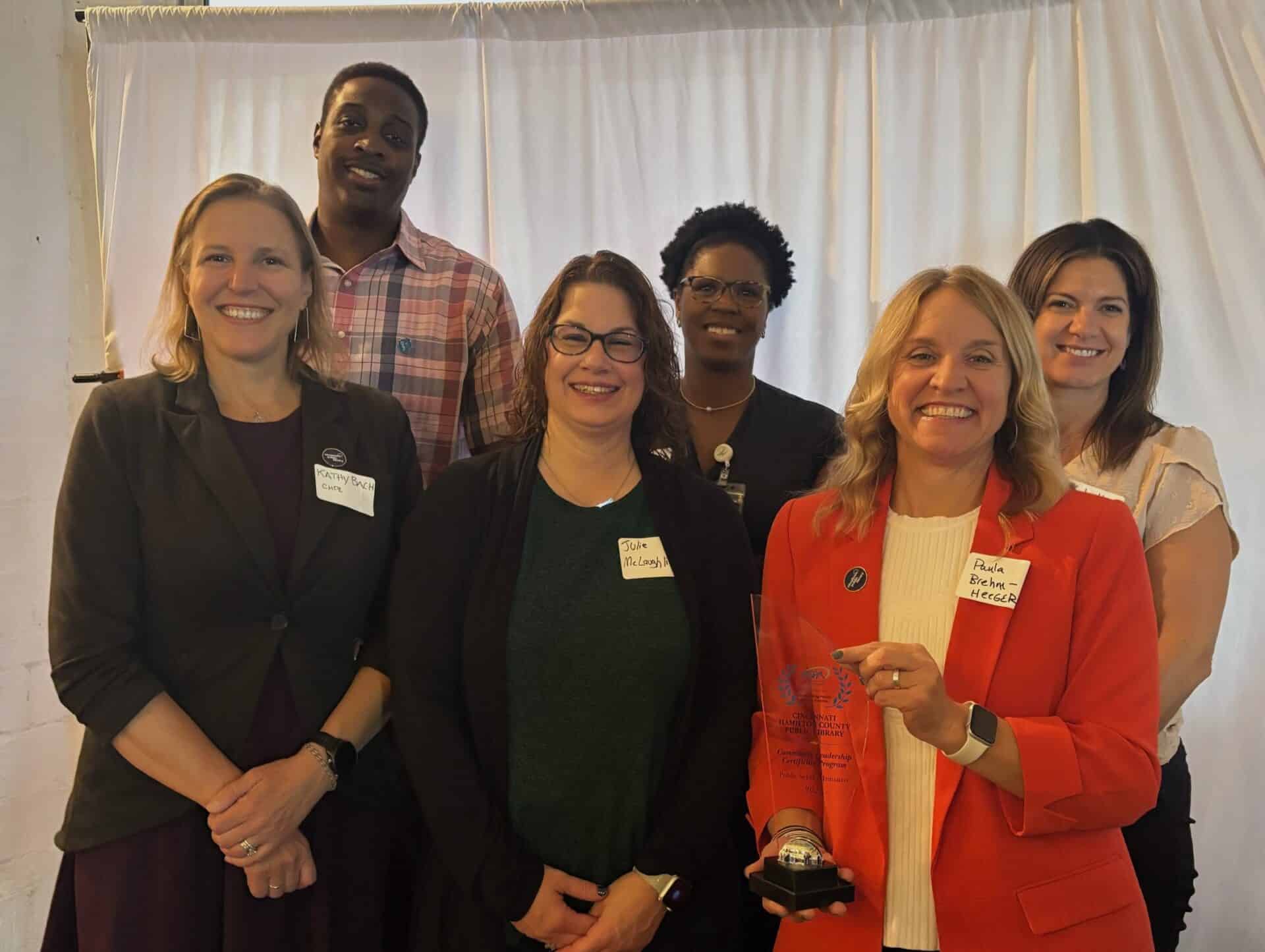 Receiving the Outstanding Public Service Award: Front – Kathy Bach, CHPL; Julie McLaughlin, Cincinnati State; Paula Brehm-Heeger, CHPL Director. Back – Community Leadership Certificate students Michael Guess and Jenna Felsheim; Kyla Hardin, CHPL.