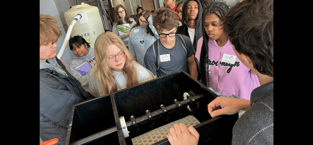 Examining a water filter at HS Environmental Day - Nov. 2025