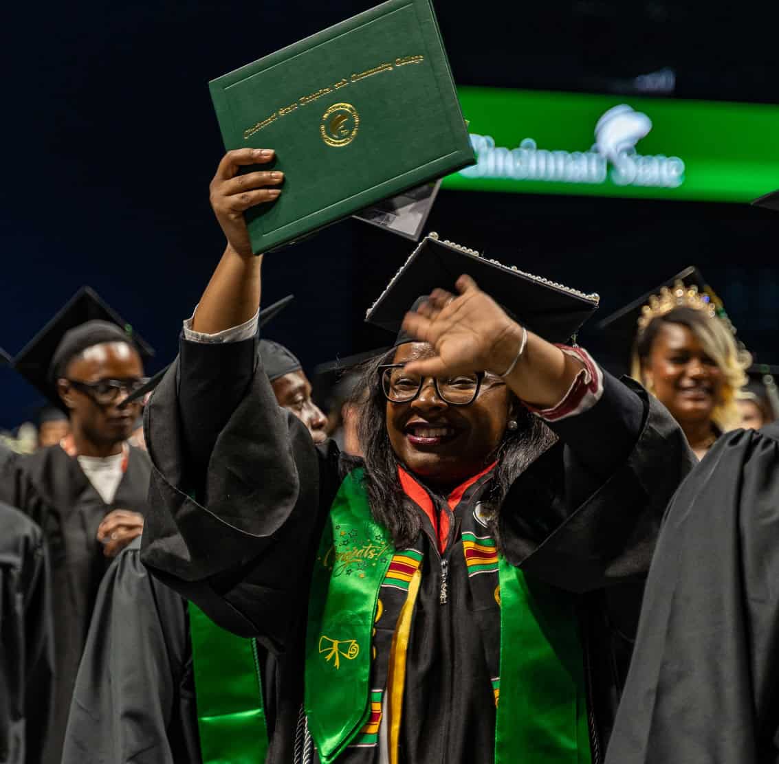 Graduate holding diploma
