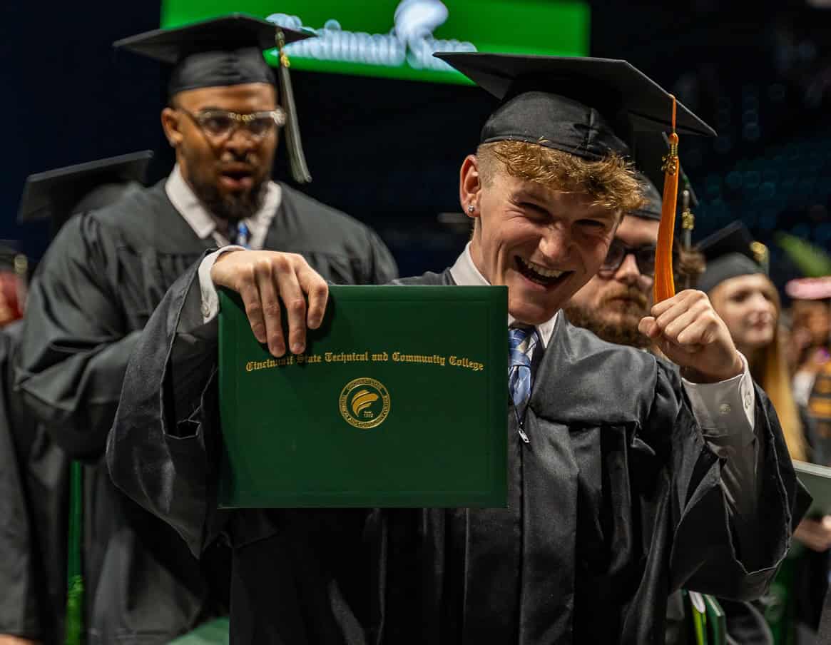 Graduate holding diploma