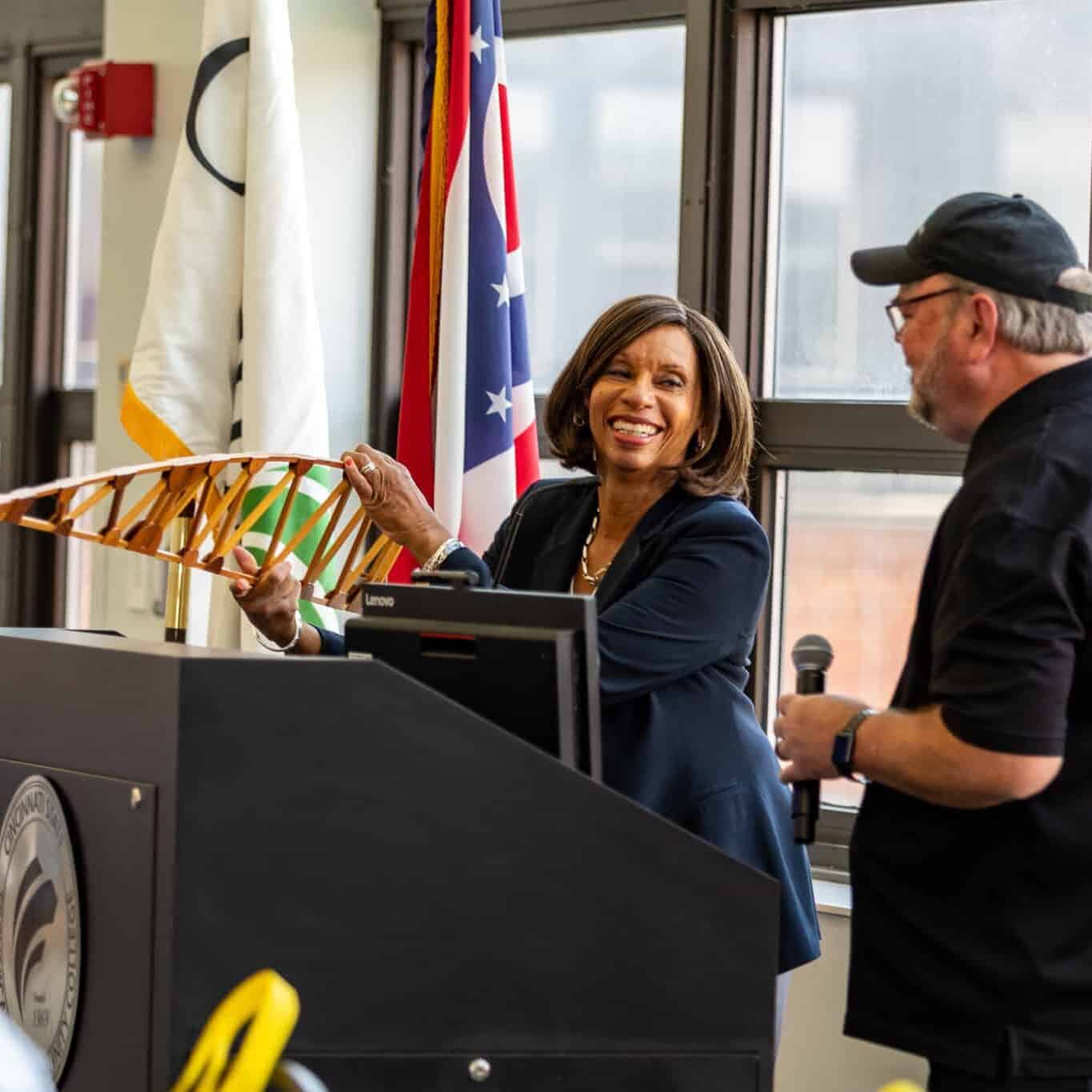 Monica Posey receiving an airplane wing rib from Jeff Wright