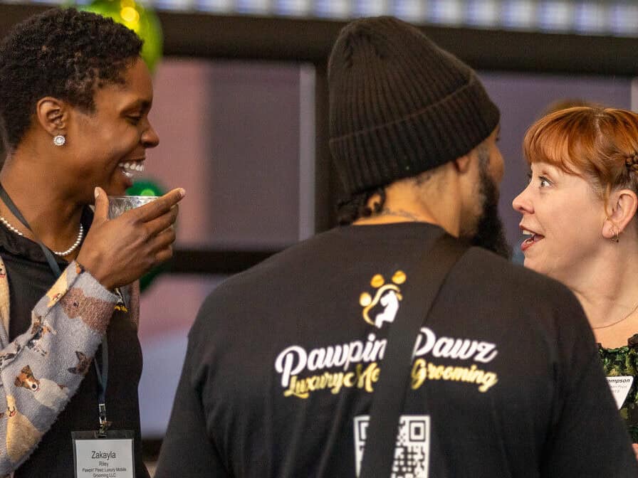 a group of people talking at a networking event
